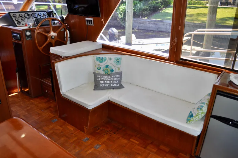 Freakin' Awesome Yacht Photos Pics Interior of 1990 Ocean Alexander 42 Sedan with white seating and wooden helm.