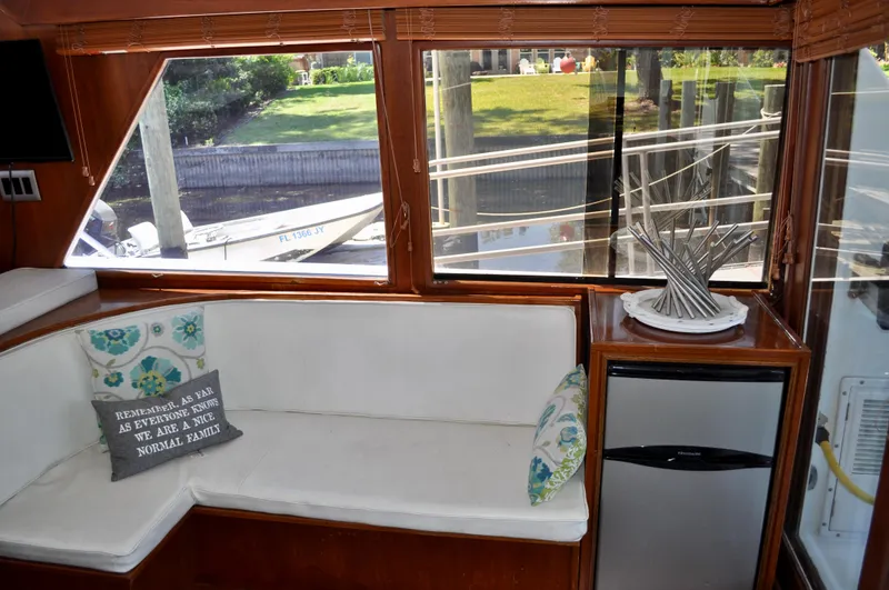 Freakin' Awesome Yacht Photos Pics Interior of 1990 Ocean Alexander 42 Sedan with white seating and decorative pillows.