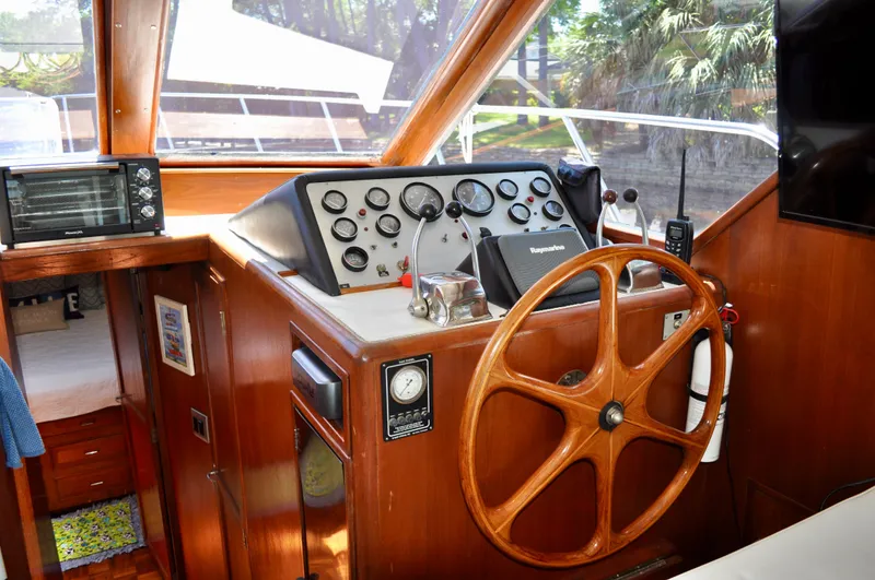 Freakin' Awesome Yacht Photos Pics 1990 Ocean Alexander 42 Sedan helm with wooden steering wheel and navigation instruments.