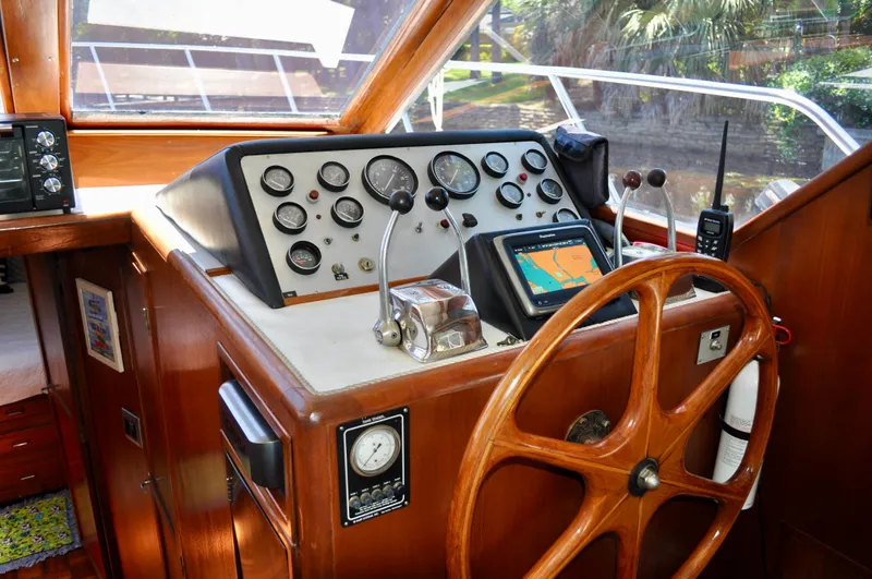 Freakin' Awesome Yacht Photos Pics 1990 Ocean Alexander 42 Sedan helm with wooden wheel, gauges, and navigation equipment.