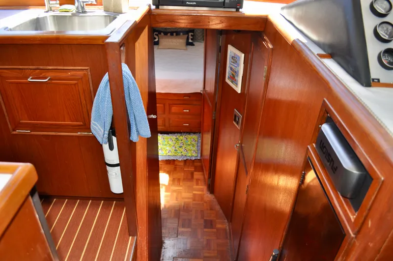 Freakin' Awesome Yacht Photos Pics Interior of 1990 Ocean Alexander 42 Sedan yacht with wooden cabinetry and cozy cabin.