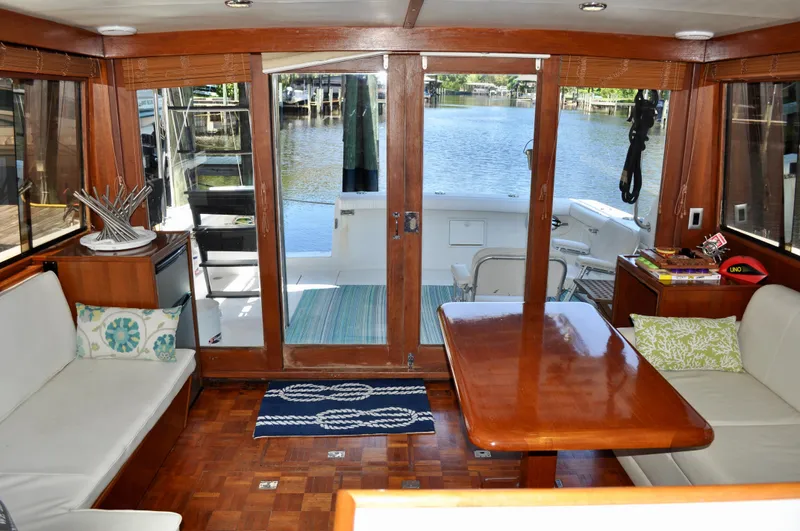 Freakin' Awesome Yacht Photos Pics Interior of 1990 Ocean Alexander 42 Sedan yacht with wooden furnishings and waterfront view.