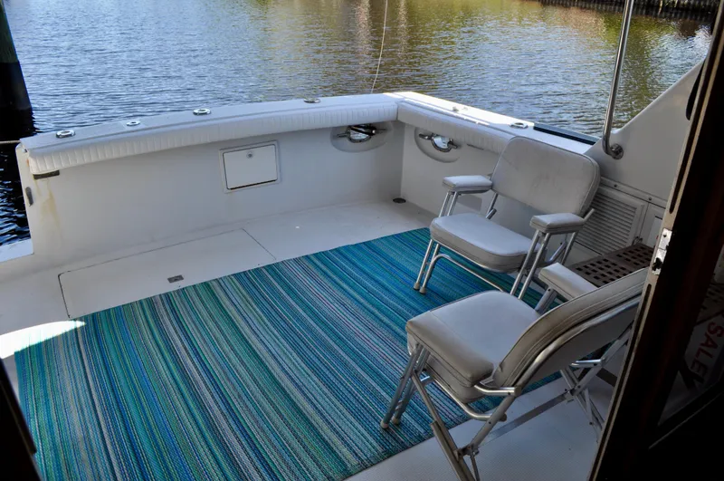 Freakin' Awesome Yacht Photos Pics 1990 Ocean Alexander 42 Sedan boat deck with chairs and blue striped rug.