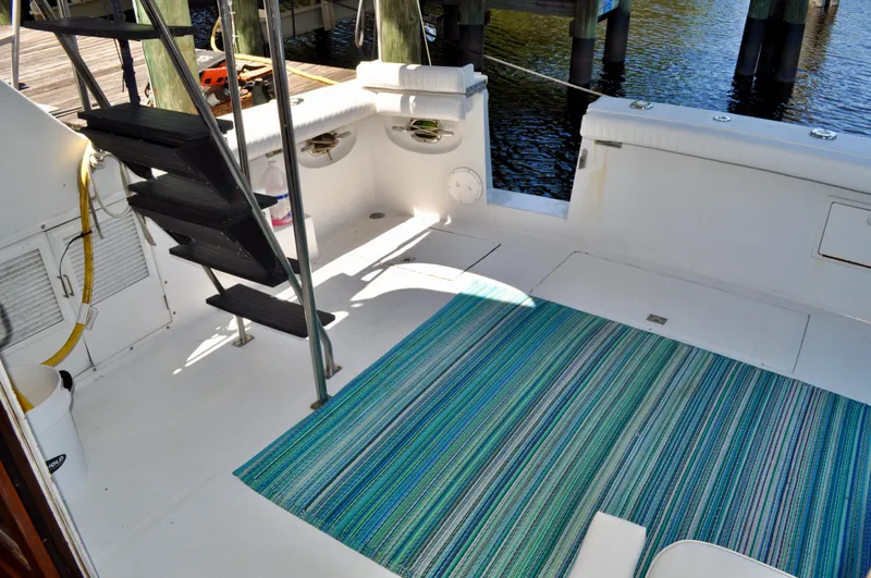 Freakin' Awesome Yacht Photos Pics 1990 Ocean Alexander 42 Sedan yacht deck with striped rug and stairs.