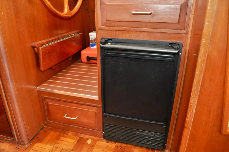 Freakin' Awesome Yacht Photos Pics Interior of 1990 Ocean Alexander 42 Sedan with wooden cabinetry and compact refrigerator.