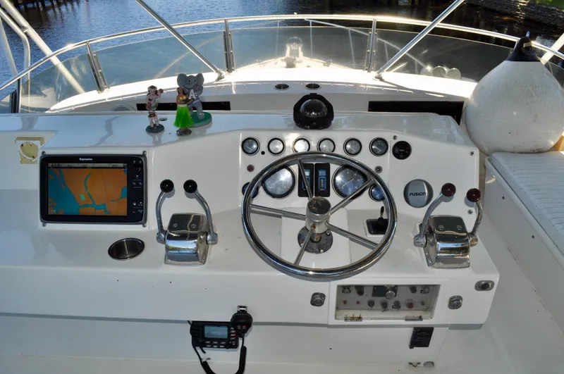 Freakin' Awesome Yacht Photos Pics Cockpit of 1990 Ocean Alexander 42 Sedan with steering wheel, controls, and navigation system.