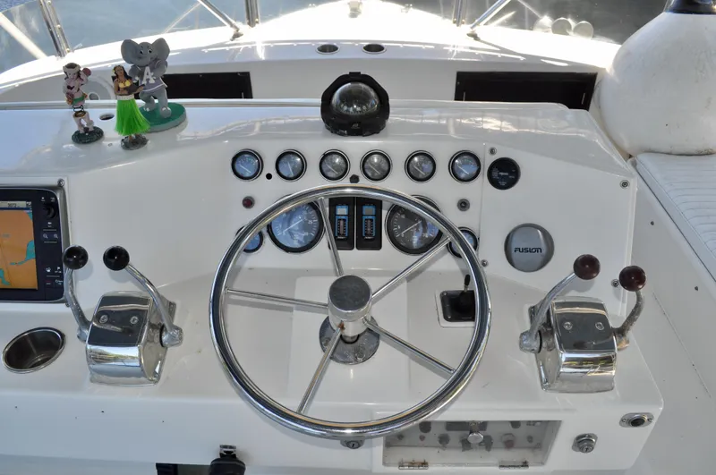 Freakin' Awesome Yacht Photos Pics 1990 Ocean Alexander 42 Sedan helm with steering wheel, gauges, and controls.