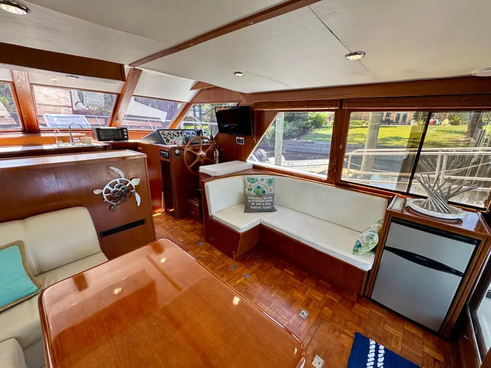 Freakin' Awesome Yacht Photos Pics Interior of 1990 Ocean Alexander 42 Sedan yacht with wood finish and seating area.