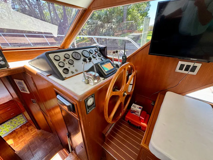 Freakin' Awesome Yacht Photos Pics Cockpit of 1990 Ocean Alexander 42 Sedan with wooden steering wheel and navigation instruments.