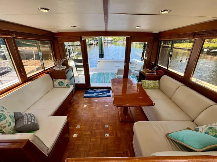 Freakin' Awesome Yacht Photos Pics Luxurious interior of 1990 Ocean Alexander 42 Sedan yacht with elegant seating and waterfront view.