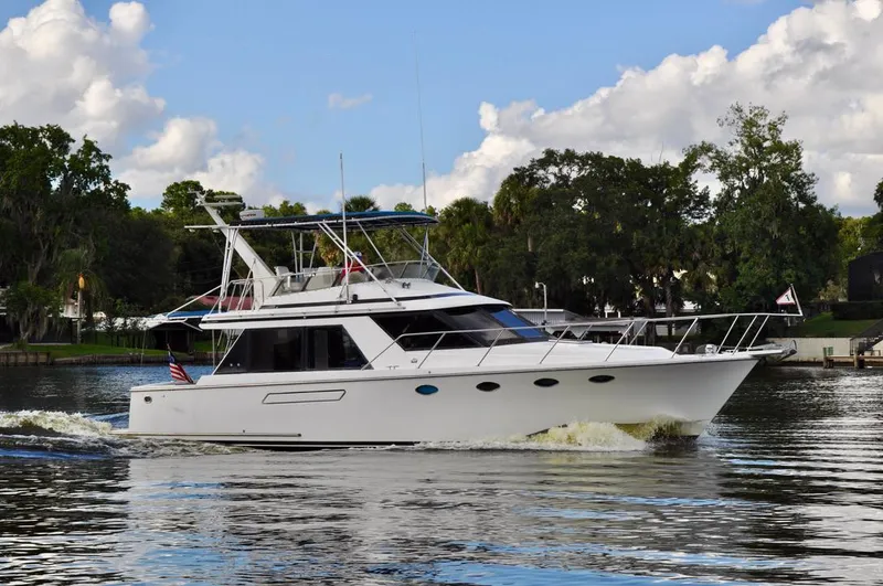 Freakin' Awesome Yacht Photos Pics 1990 Ocean Alexander 42 Sedan yacht cruising on a scenic river.