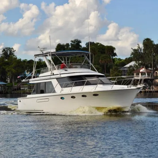 Freakin' Awesome Yacht Photos Pics Ocean Alexander 42 Sedan yacht cruising on a calm river, 1990 model.