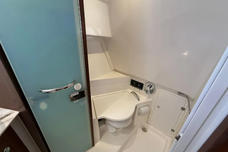 Bon Voyage Yacht Photos Pics 2019 Pursuit OS 355 Offshore boat bathroom with modern fixtures and compact design.