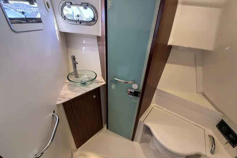 Bon Voyage Yacht Photos Pics 2019 Pursuit OS 355 Offshore boat bathroom with modern sink and toilet.