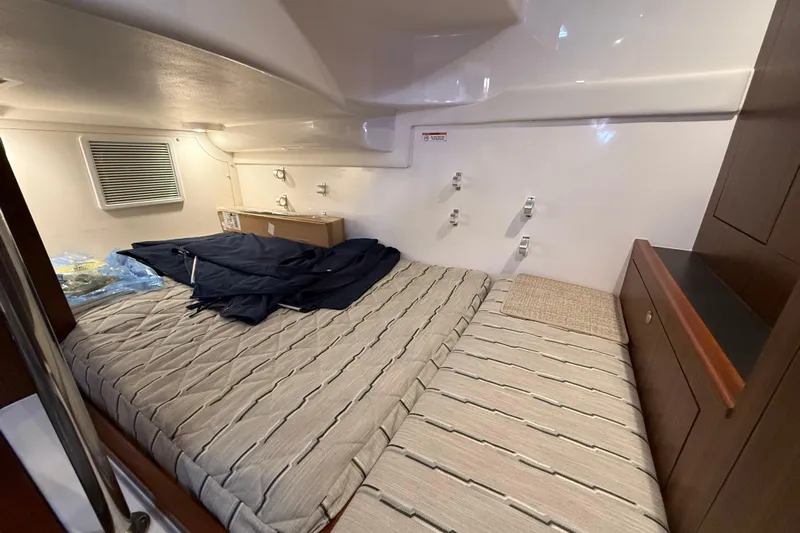 Bon Voyage Yacht Photos Pics 2019 Pursuit OS 355 Offshore cabin interior with bed and storage.