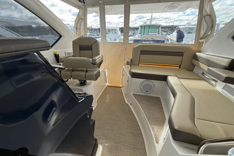 Bon Voyage Yacht Photos Pics Interior of 2019 Pursuit OS 355 Offshore boat with seating and helm station.