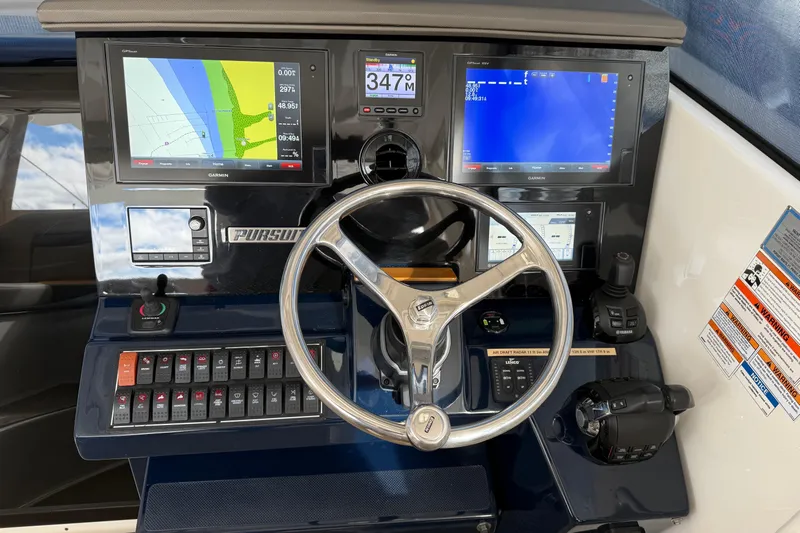 Bon Voyage Yacht Photos Pics 2019 Pursuit OS 355 Offshore helm with navigation screens and controls.