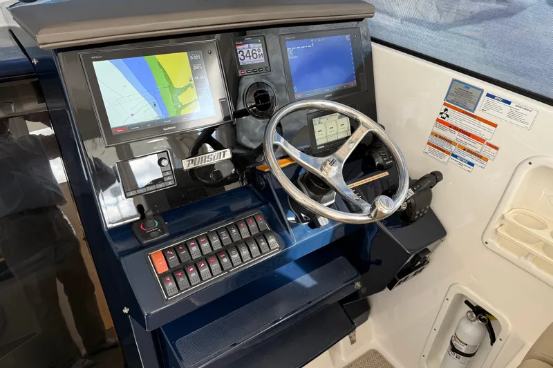Bon Voyage Yacht Photos Pics 2019 Pursuit OS 355 Offshore helm with navigation screens and controls.
