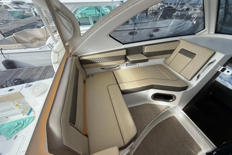 Bon Voyage Yacht Photos Pics 2019 Pursuit OS 355 Offshore boat interior with beige seating and modern design.