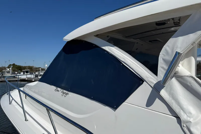 Bon Voyage Yacht Photos Pics 2019 Pursuit OS 355 Offshore boat with covered windows, docked under clear blue sky.