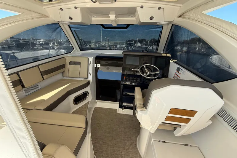 Bon Voyage Yacht Photos Pics Interior of 2019 Pursuit OS 355 Offshore boat with helm and seating area.