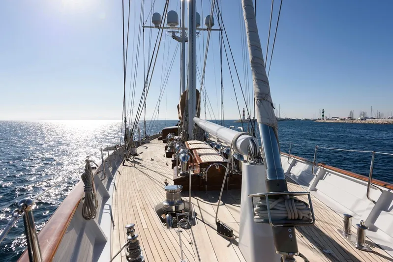 Meteor Yacht Photos Pics Royal Huisman Schooner 2007 sailing on open sea under clear blue sky.