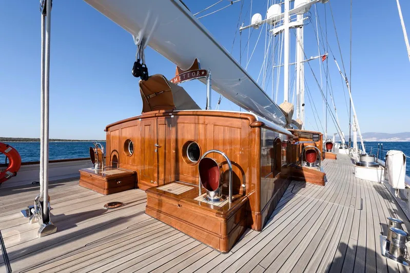 Meteor Yacht Photos Pics Luxurious 2007 Royal Huisman Schooner deck with polished wood and sleek design.
