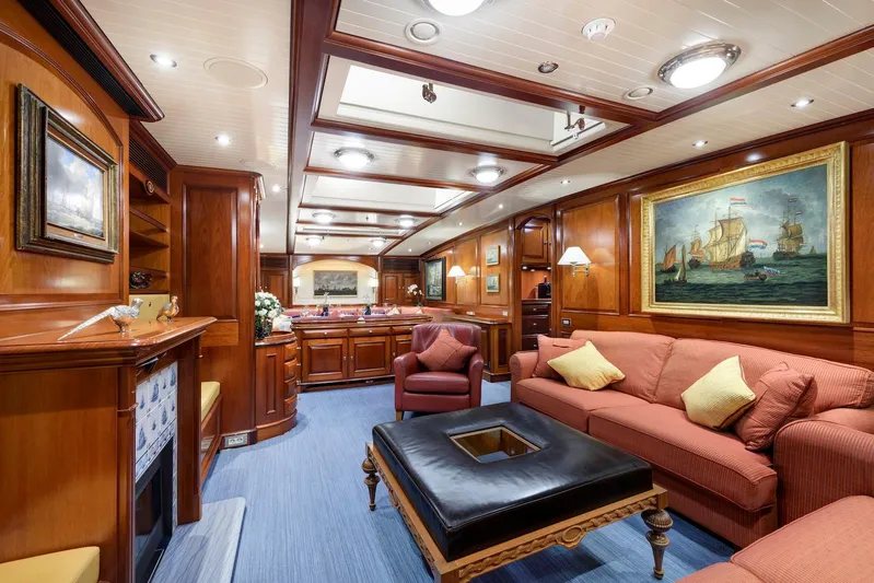 Meteor Yacht Photos Pics Luxurious interior of 2007 Royal Huisman Schooner with elegant wood paneling and plush seating.