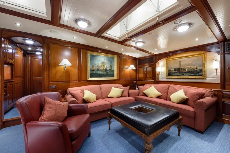 Meteor Yacht Photos Pics Luxurious interior of 2007 Royal Huisman Schooner with elegant seating and classic artwork.