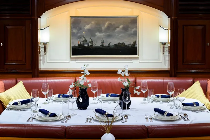 Meteor Yacht Photos Pics Luxurious dining setup on 2007 Royal Huisman Schooner, featuring elegant tableware and floral arrangements.
