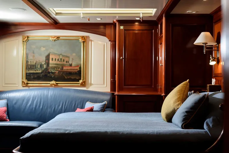 Meteor Yacht Photos Pics Luxurious interior of 2007 Royal Huisman Schooner with elegant wood paneling and artwork.