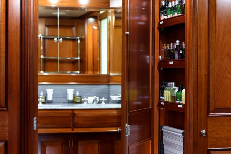 Meteor Yacht Photos Pics Luxurious wooden interior of 2007 Royal Huisman Schooner with elegant cabinetry and toiletries.