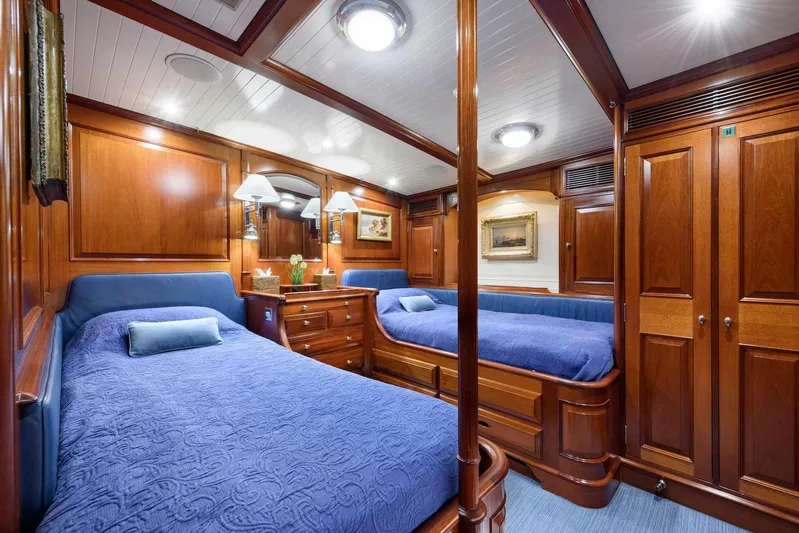Meteor Yacht Photos Pics Luxurious cabin interior of 2007 Royal Huisman Schooner with wooden furnishings and twin beds.