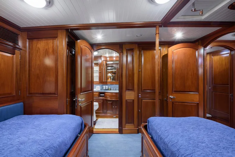 Meteor Yacht Photos Pics Luxurious wooden interior of 2007 Royal Huisman Schooner cabin with twin beds and ensuite bathroom.