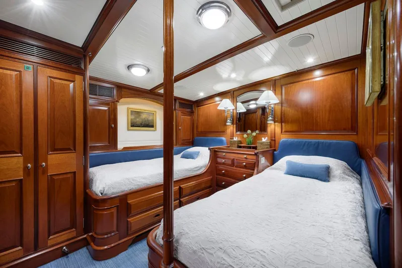Meteor Yacht Photos Pics Luxurious wooden cabin interior of 2007 Royal Huisman Schooner with twin beds and elegant decor.