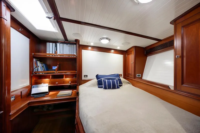 Meteor Yacht Photos Pics Luxurious cabin interior of 2007 Royal Huisman Schooner with wooden furnishings and cozy bedding.