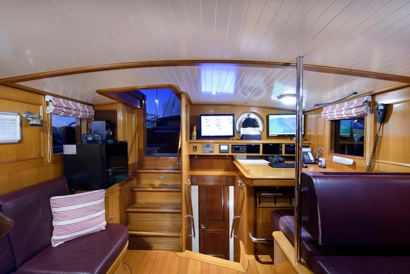 Meteor Yacht Photos Pics Luxurious interior of 2007 Royal Huisman Schooner with wood finish and modern navigation equipment.