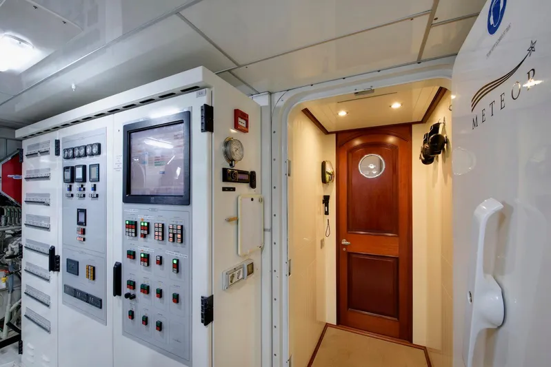 Meteor Yacht Photos Pics Control room of 2007 Royal Huisman Schooner with advanced navigation equipment and wooden door.