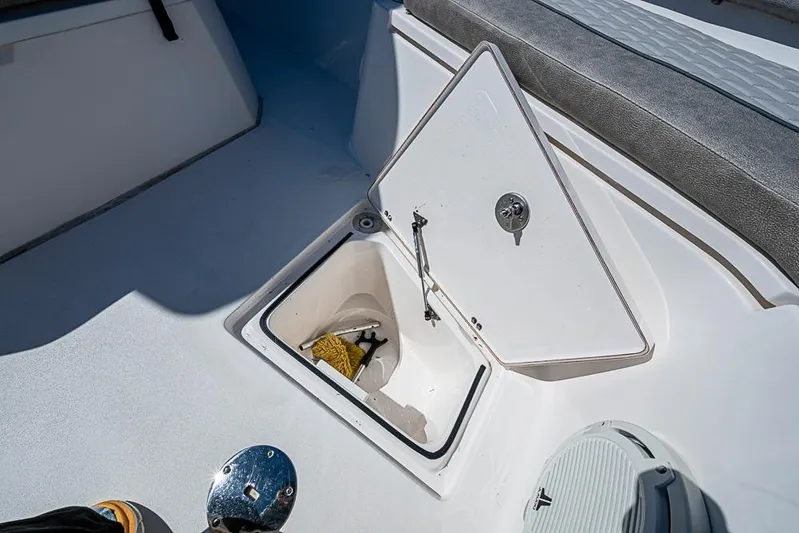  Yacht Photos Pics 2018 Sea Fox 328 Commander boat storage compartment with open hatch and cleaning supplies.
