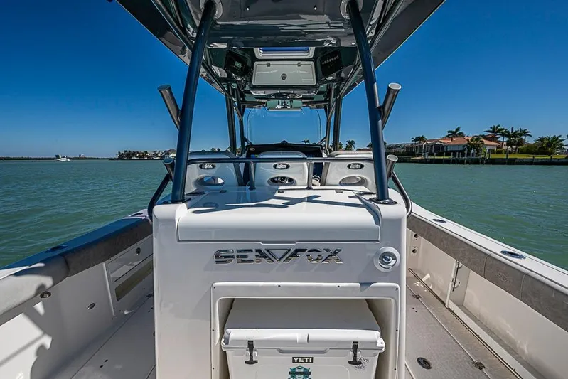  Yacht Photos Pics 2018 Sea Fox 328 Commander boat on water, clear sky, luxury waterfront homes.