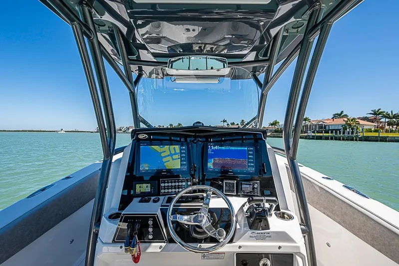  Yacht Photos Pics 2018 Sea Fox 328 Commander boat dashboard with navigation screens on a sunny day.