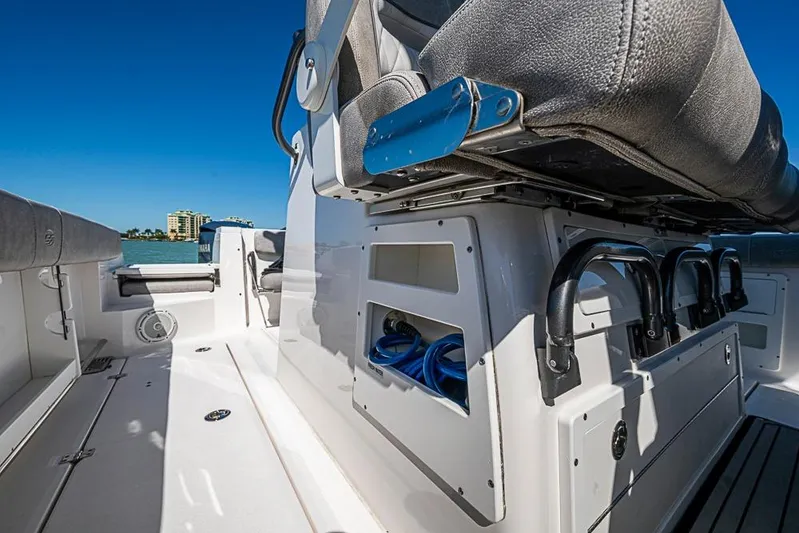  Yacht Photos Pics 2018 Sea Fox 328 Commander boat interior with seating and storage, under clear blue sky.