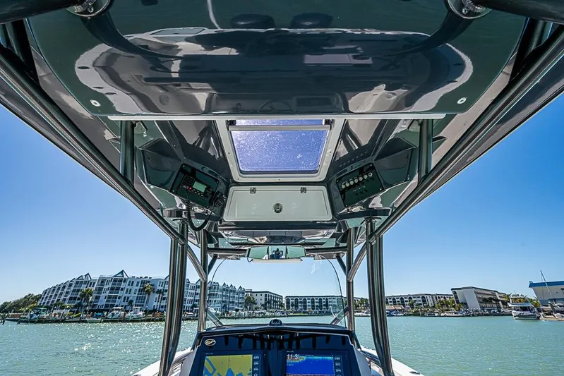  Yacht Photos Pics 2018 Sea Fox 328 Commander boat interior with navigation equipment, overlooking waterfront buildings.