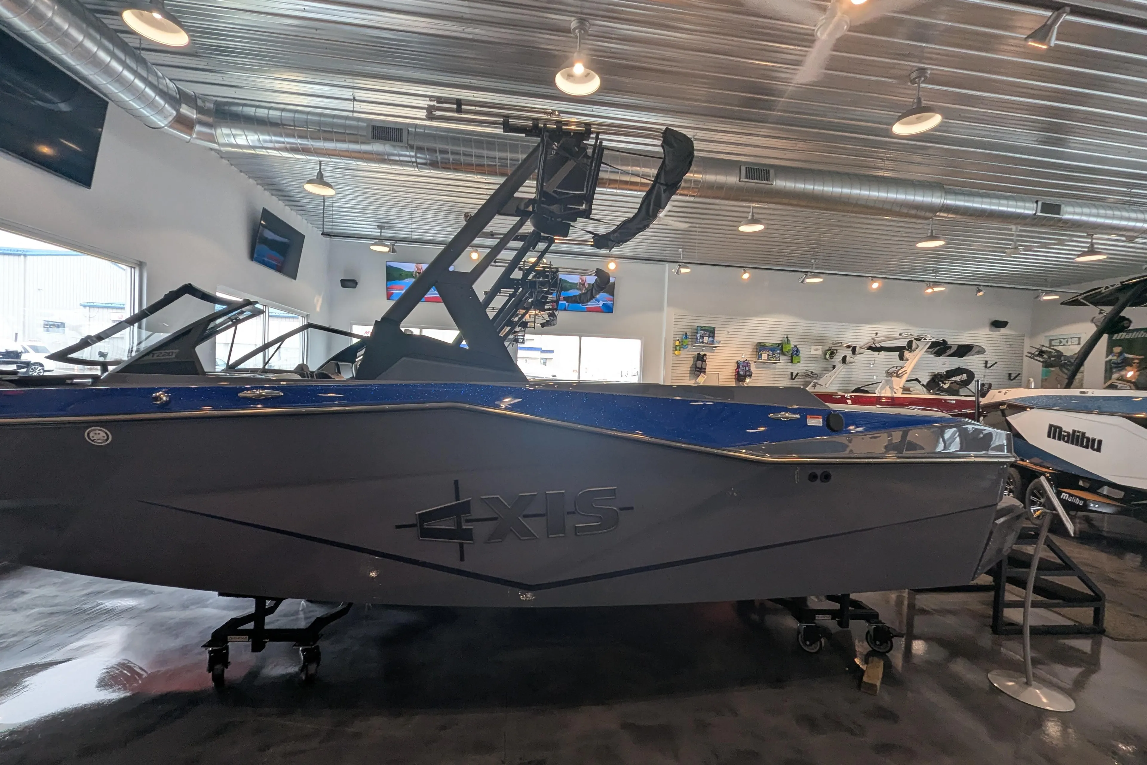 2025 Axis T220 boat displayed in a showroom with modern interior design.