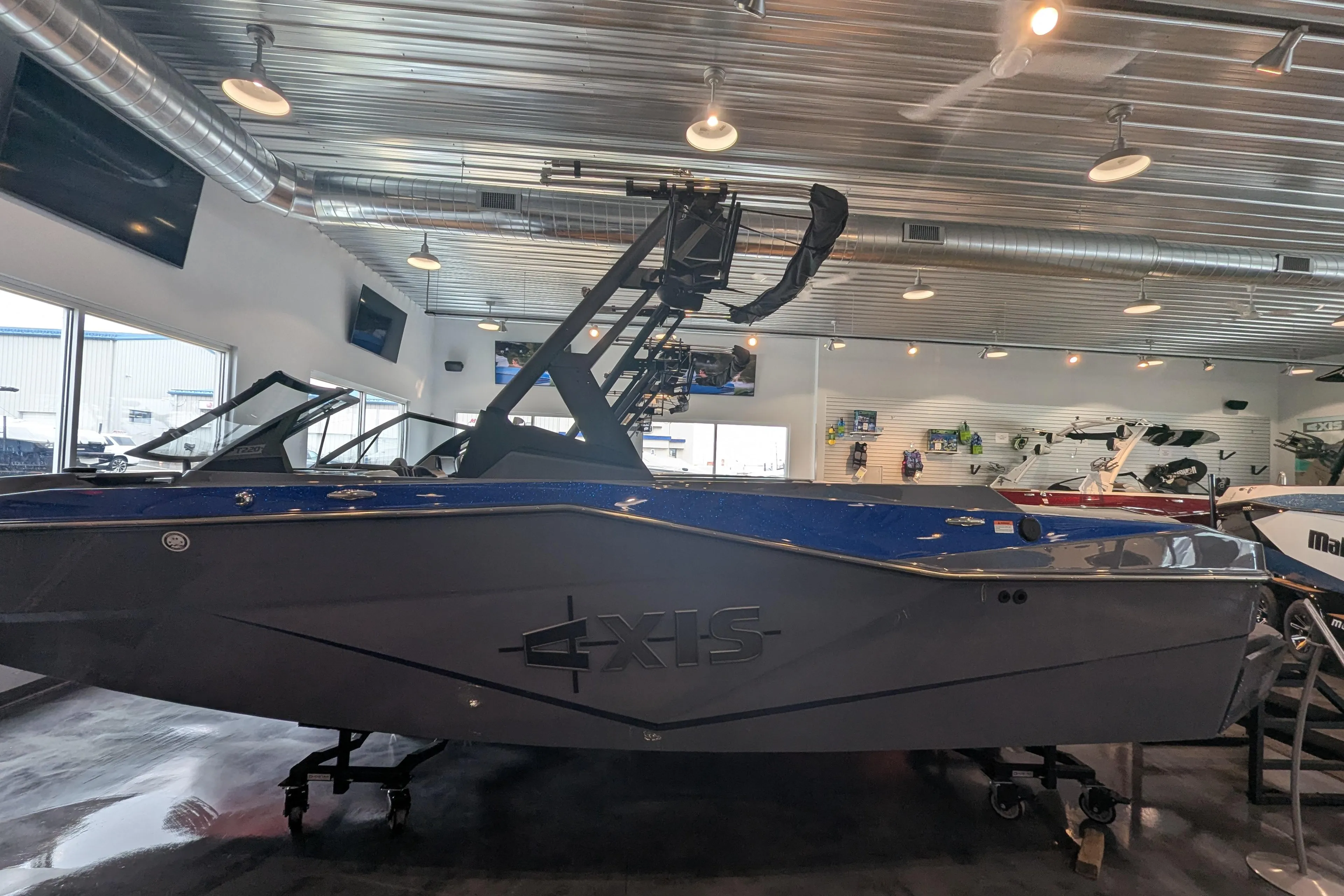 2025 Axis T220 boat displayed in a showroom with modern lighting.
