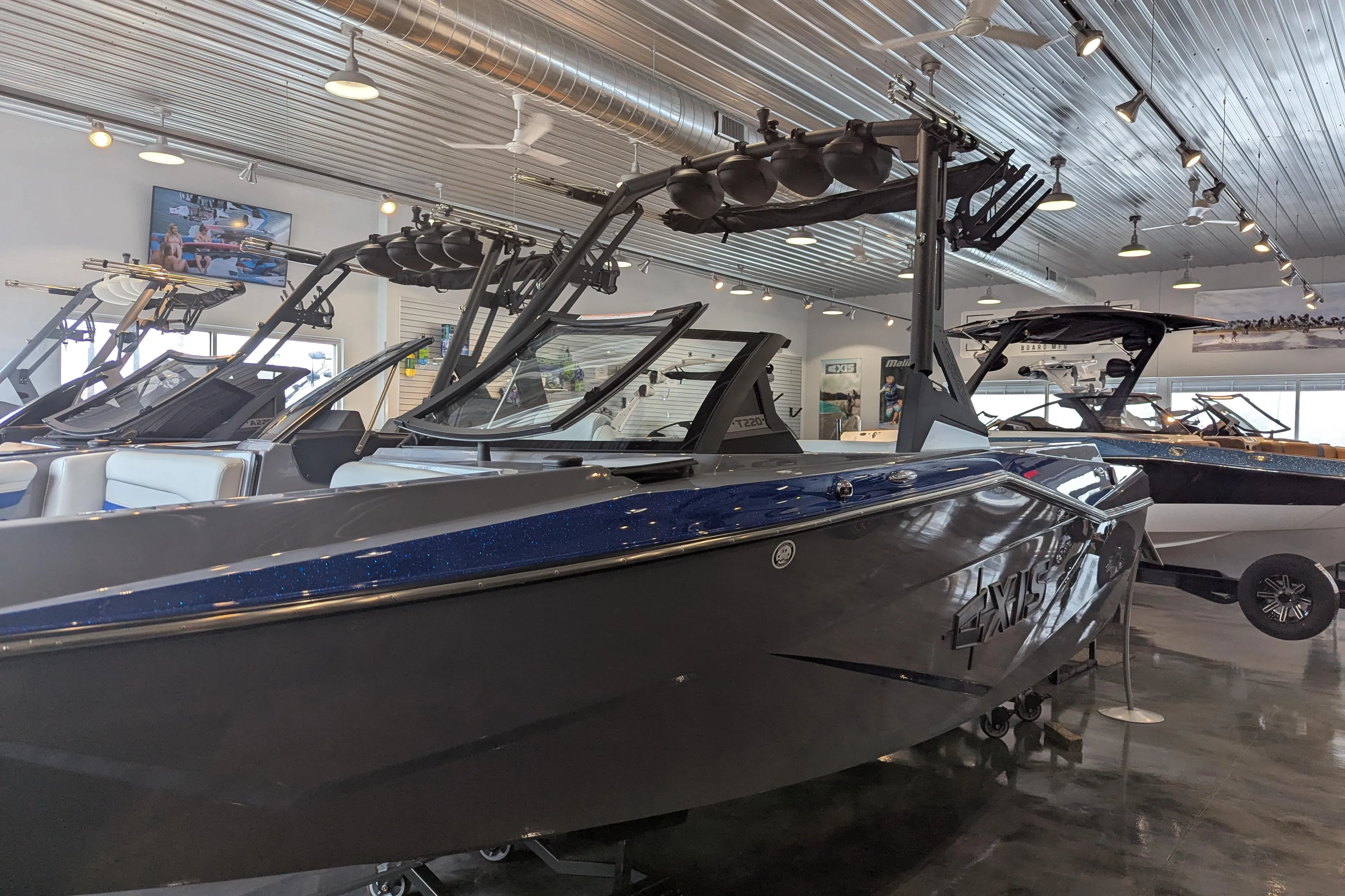 2025 Axis T220 boat in showroom, sleek design, modern features, metallic finish.