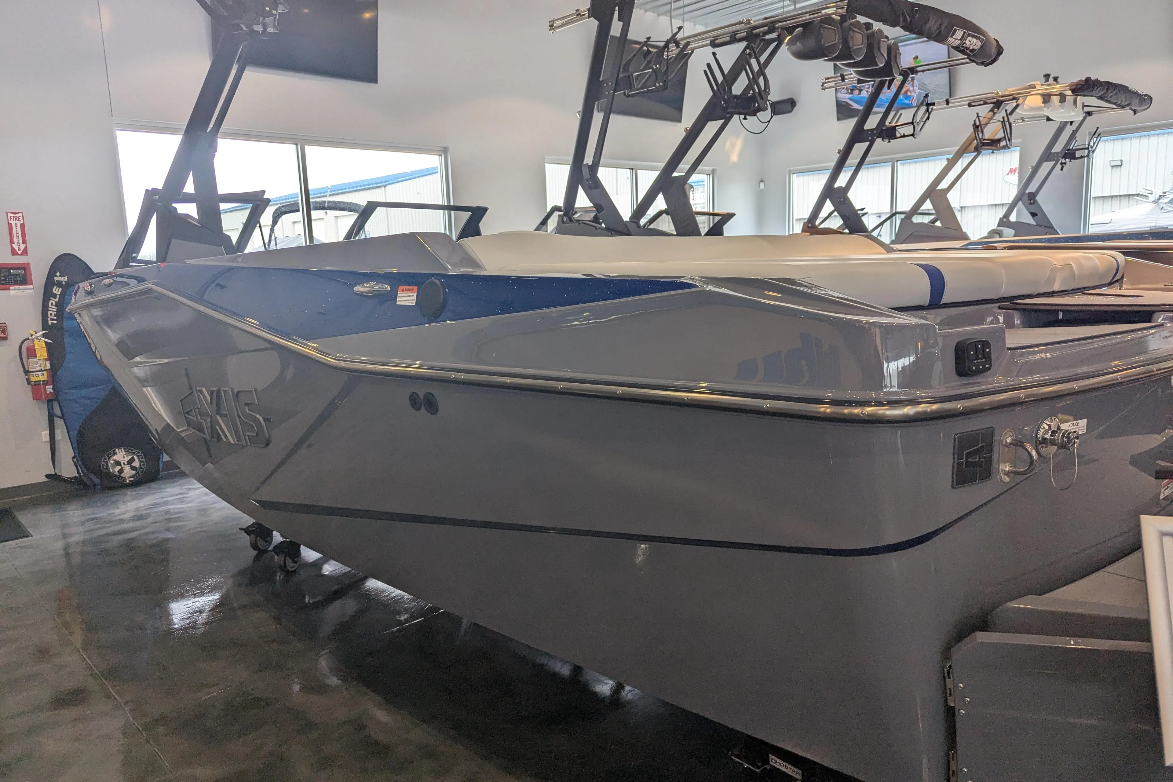 2025 Axis T220 boat in showroom, sleek gray design with modern features.