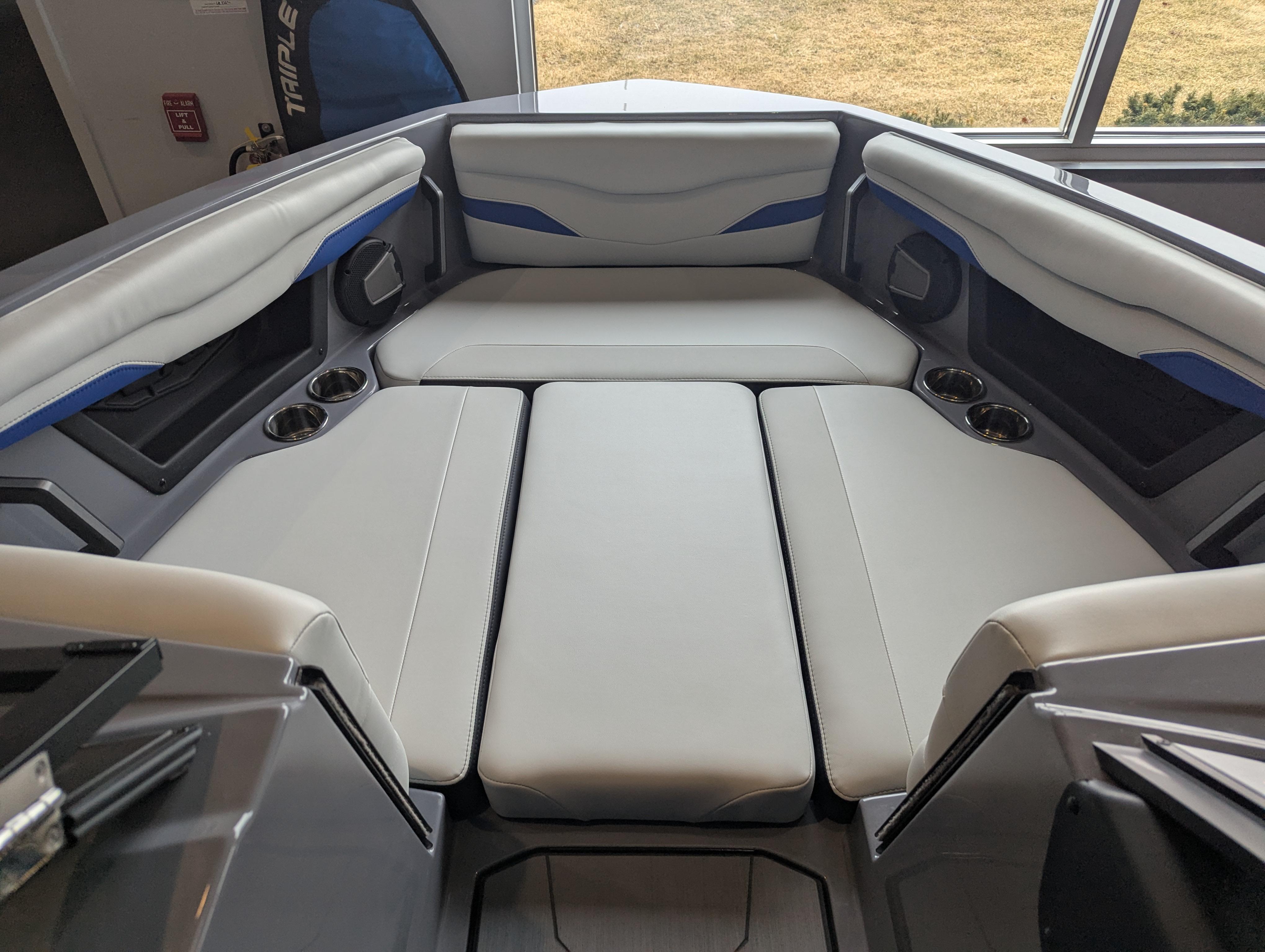 2025 Axis T220 boat interior with cushioned seating and cup holders.