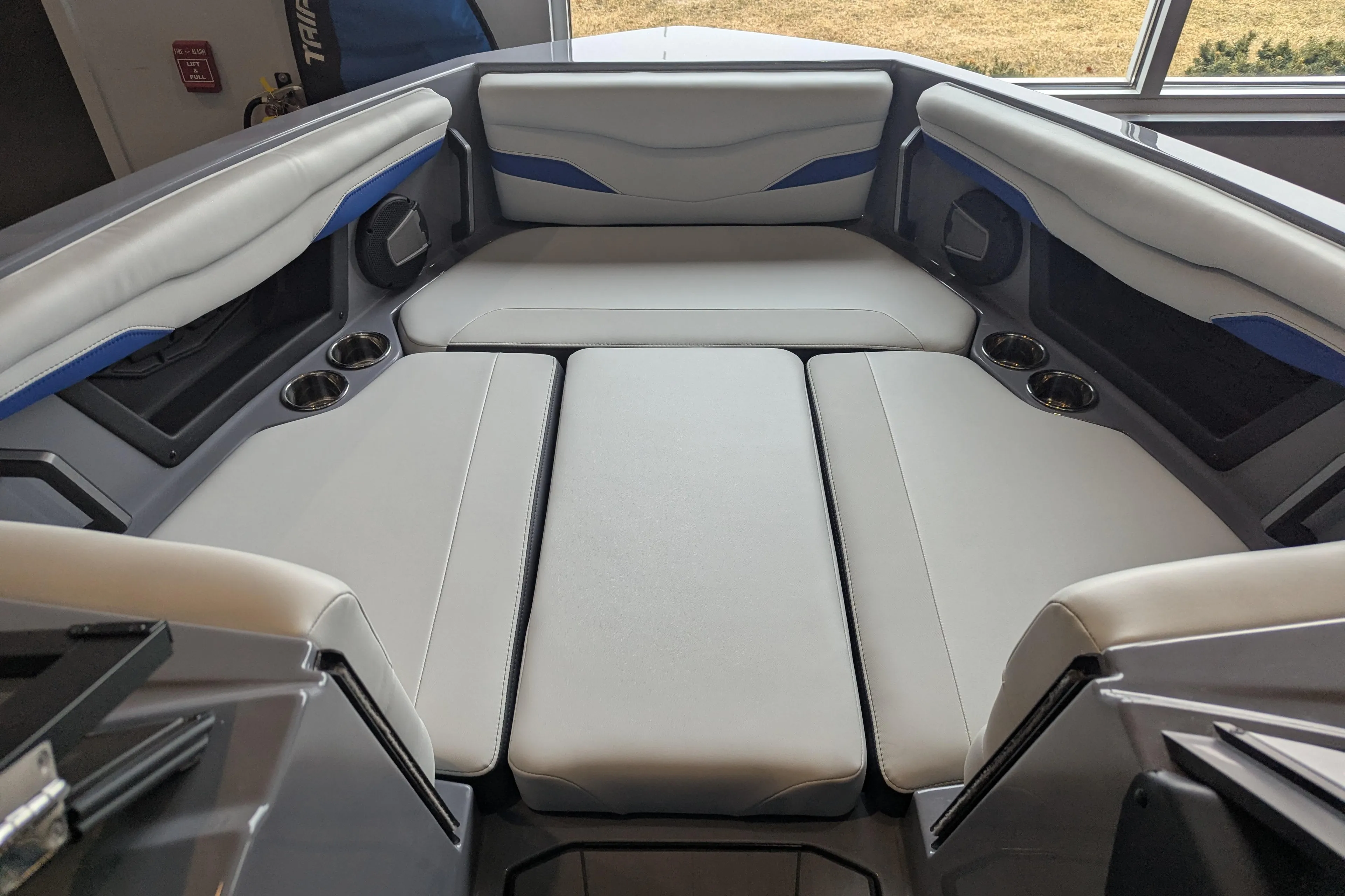 2025 Axis T220 boat interior with cushioned seating and cup holders.