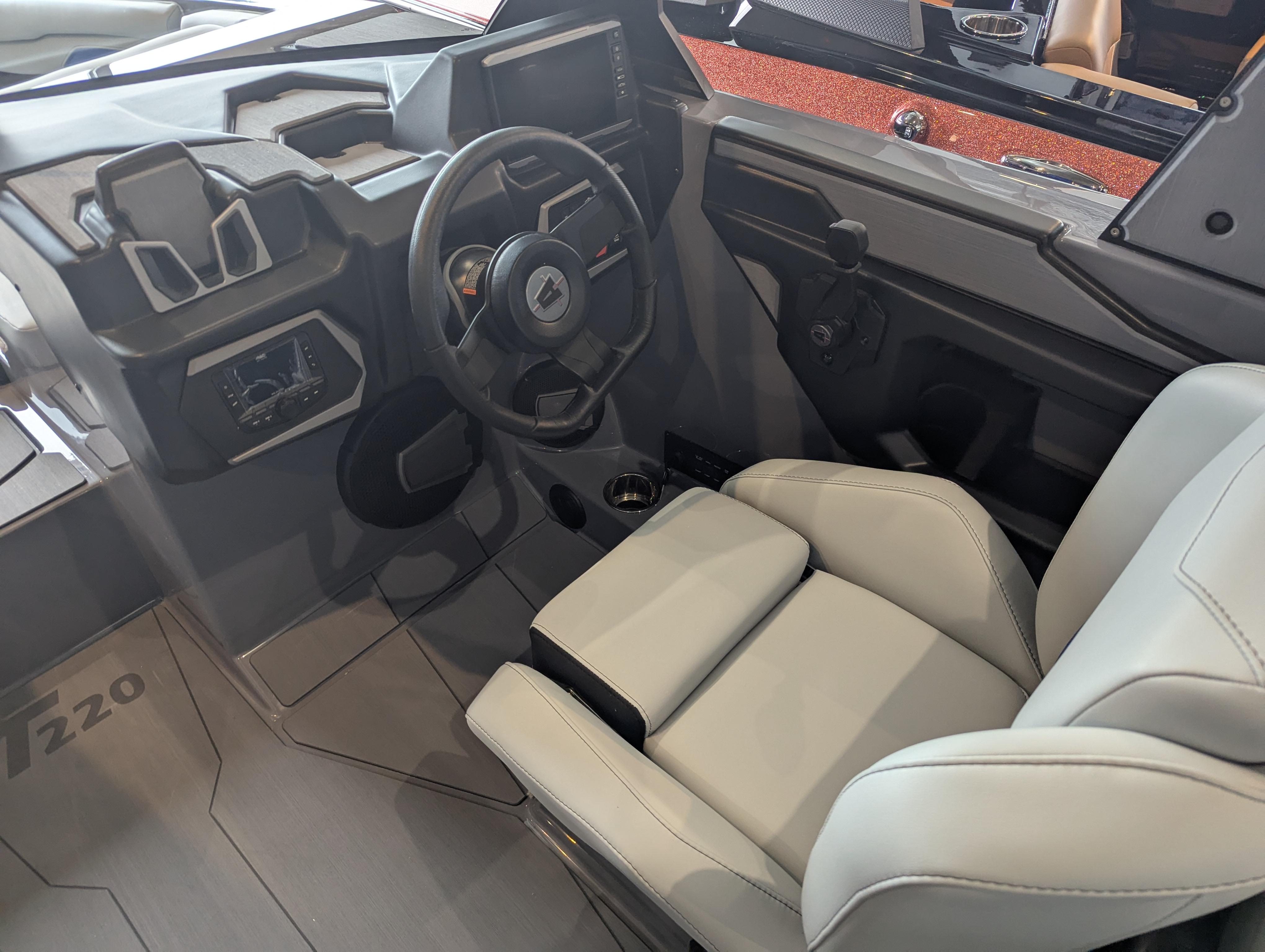 2025 Axis T220 boat interior with modern steering wheel and comfortable seating.
